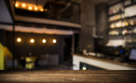 blurred background of bar and dark brown desk space of retro woodの写真素材