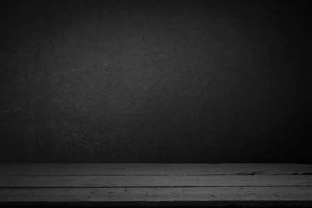 cement floor in dark room with spot light. black background.