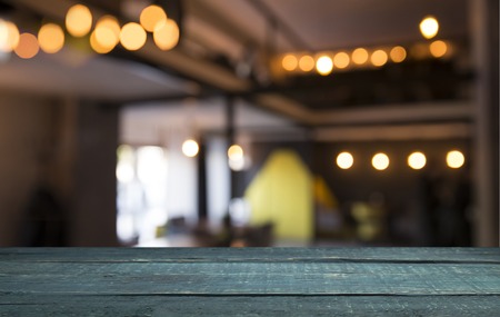 blurred background of bar and dark brown desk space of retro woodの写真素材