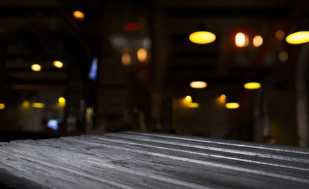 blurred background of bar and dark brown desk space of retro woodの写真素材