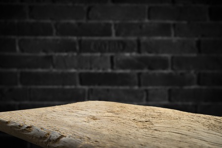 Old wooden table with brick backgroundの写真素材