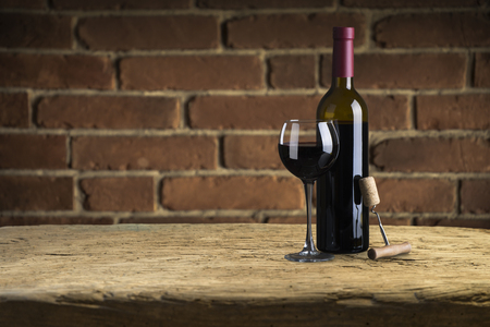 Red and white wine in bottles in wine shopの写真素材