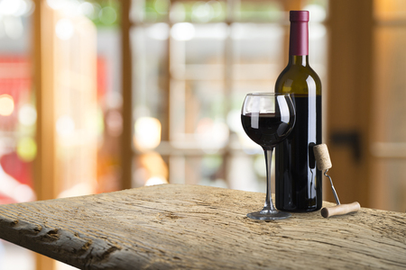 Red and white wine tasting in the winery: full wine glasses next to a window and lush vineyard on the background, winemaking conceptの写真素材