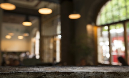blurred background of bar and dark brown desk space of retro wood