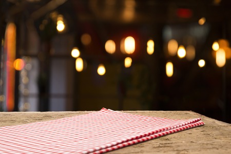 Table background with napkin and blurred bar background spaceの写真素材