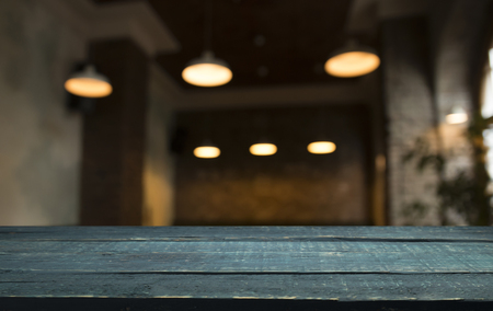 Wood table top with reflect on blur of lighting in night cafe,の写真素材