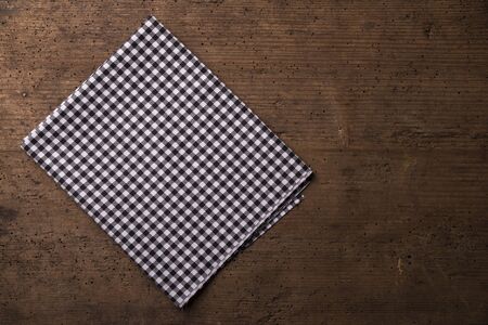 Empty wooden deck table and red checked tablecloth over mint wallpaper backgroundの写真素材