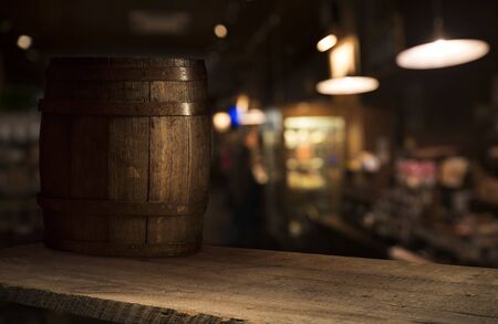 Beer barrel with beer glasses on a wooden table. The dark brown background.の写真素材