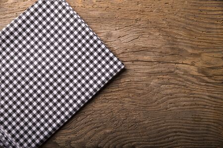 Empty wooden deck table and red checked tablecloth over mint wallpaper backgroundの写真素材