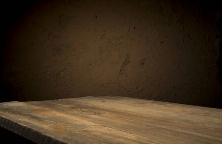 Empty wood table top on blur light gold bokeh of cafe restaurant in dark background.