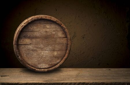 background of barrel and worn old table of woodの写真素材