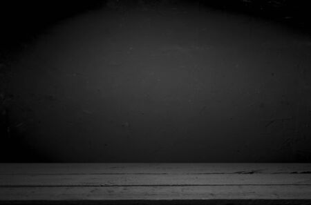 cement floor in dark room with spot light. black background.の写真素材