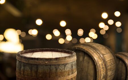 Empty wood table top on blur light gold bokeh of cafe restaurant in dark backgroundの写真素材