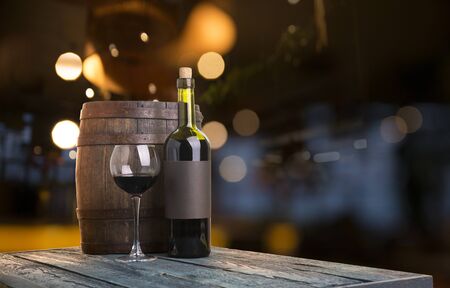 Expensive wine bottles collection and wooden barrel in the cellar, wine tasting and production conceptの写真素材