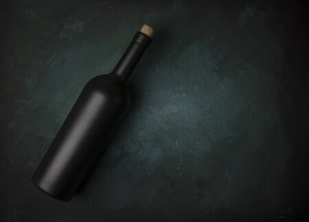 Red wine glasses and bottle on stone background. Top view with copy spaceの写真素材