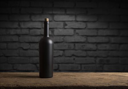 Wine tasting experience in the rustic cellar and wine bar: red wine glass and collection of excellent wines on the backgroundの写真素材