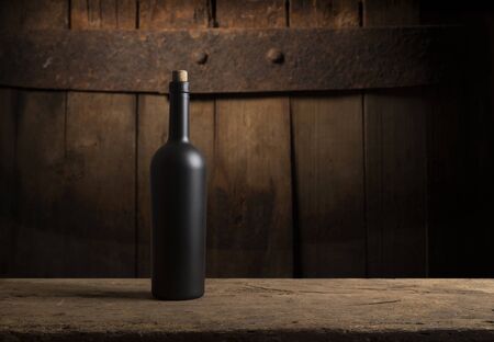 Wine tasting experience in the rustic cellar and wine bar: red wine glass and collection of excellent wines on the backgroundの写真素材