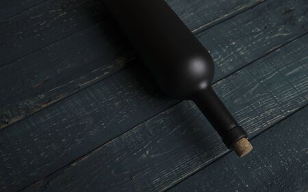 Wine tasting experience in the rustic cellar and wine bar: red wine glass and collection of excellent wines on the backgroundの写真素材