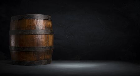 Beer barrel with beer glasses on a wooden table. The dark brown background.の写真素材
