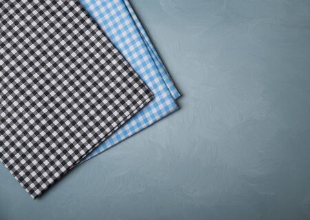 Top view of checkered kitchen tablecloth on concrete background.の写真素材