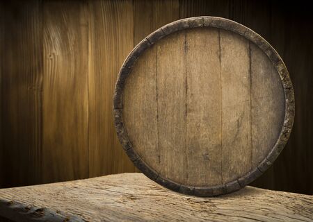 background of barrel and worn old table of woodの写真素材
