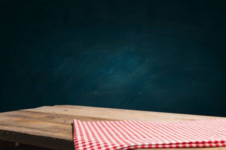 Empty wooden table with tablecloth for product montage display