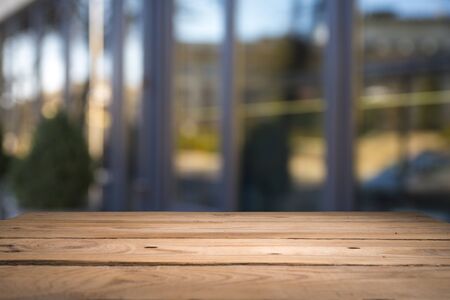 Empty tropical wood table and blurred garden cafe light background. product display...