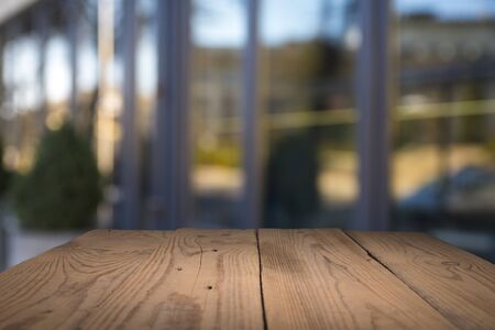 Empty tropical wood table and blurred garden cafe light background. product display...