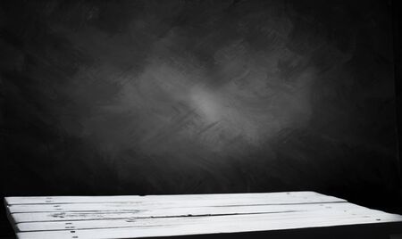 Wooden table with dark blurred background.の写真素材