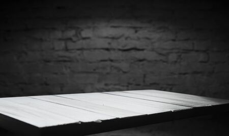 Wooden table with dark blurred background.の写真素材