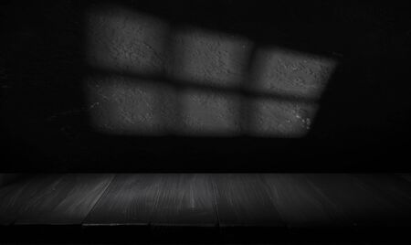 Wooden table with dark blurred background.の写真素材