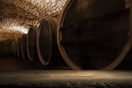 background of barrel and worn old table of woodの写真素材
