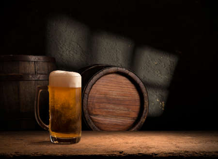 Beer style- bottle, beer in the glass and covers on wooden table. Free space for text. Top viewの写真素材