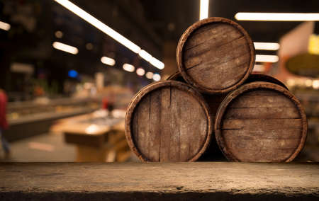 Beer barrel with beer glasses on a wooden table. The dark brown background.の写真素材