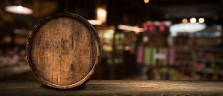Wooden barrel on a table and textured backgroundの写真素材