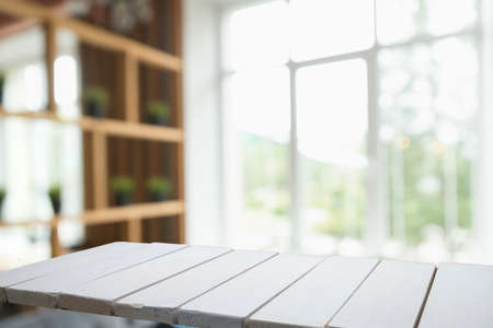 Wooden table on defocuced window with curtain backgroundの写真素材