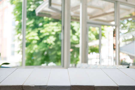 Wooden table on defocuced window with curtain backgroundの写真素材