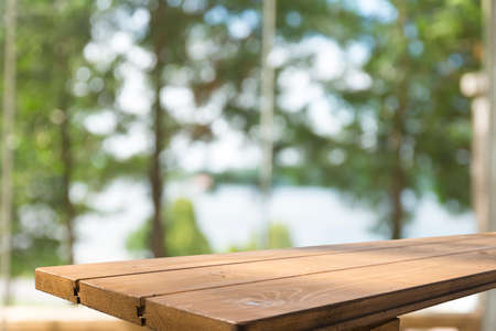 Wooden table on defocuced window with curtain backgroundの写真素材