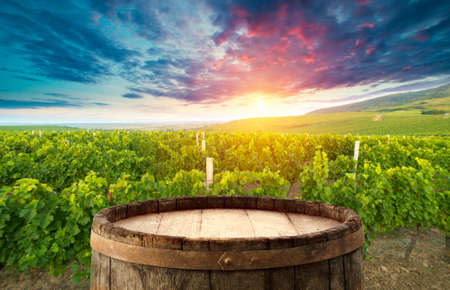 red wine bottle and wine glass on wodden barrelの写真素材