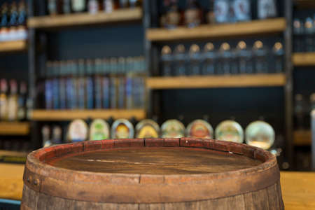 Oktoberfest beer barrel and beer glasses with wheat and hops on wooden tableの写真素材