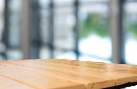 Empty wooden table top with lights bokeh on blur restaurant background.の写真素材