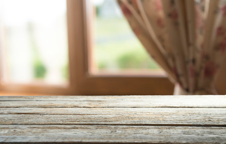 Wooden white table in home interior and white window with fall landscapeの写真素材