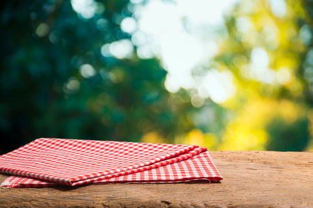 Empty table decorated with red checkered towel