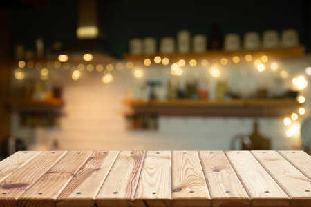 Empty wooden desk on blurred kitchen windowの写真素材