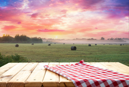 Wooden table top on blur rice fieldの写真素材