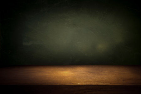 Wooden table with dark blurred background. High