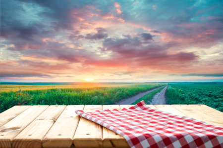 Wooden table top with blurry tea plantationの写真素材