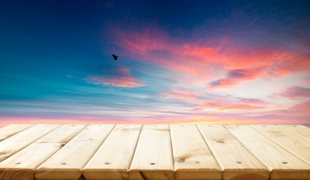 Wooden table top with blurry tea plantationの写真素材