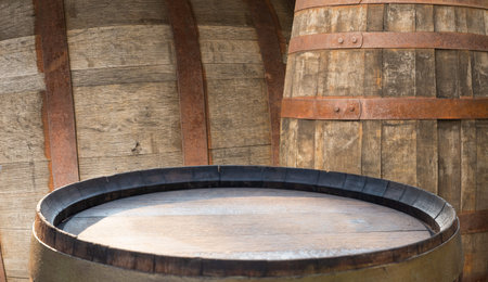 Wooden barrels in rustic cellar, warm amber