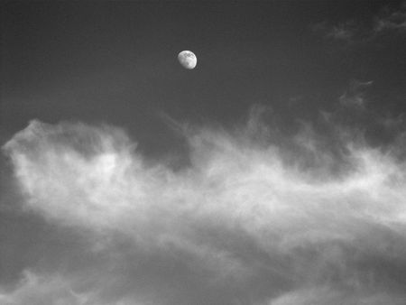 Moon among the cloudsの写真素材